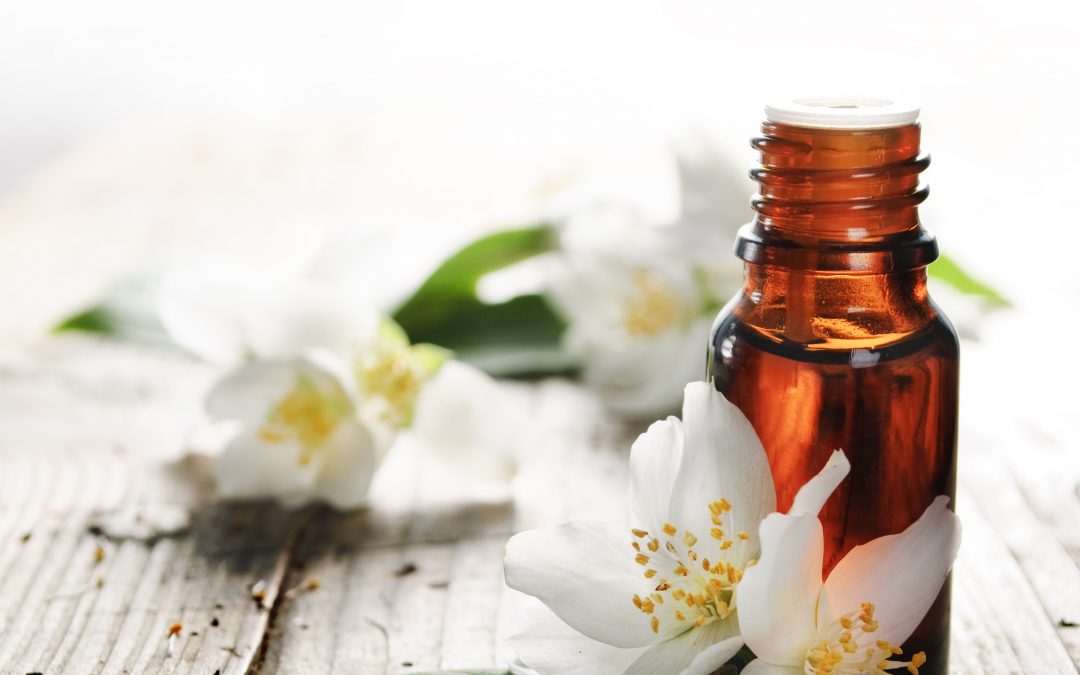 essential oil bottle and flowers